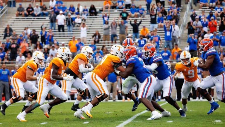 Tennessee Volunteers orange jerseys vs Florida Gators blue in intense football matchup at The Swamp, QB throw during 2025 SEC game prediction highlights